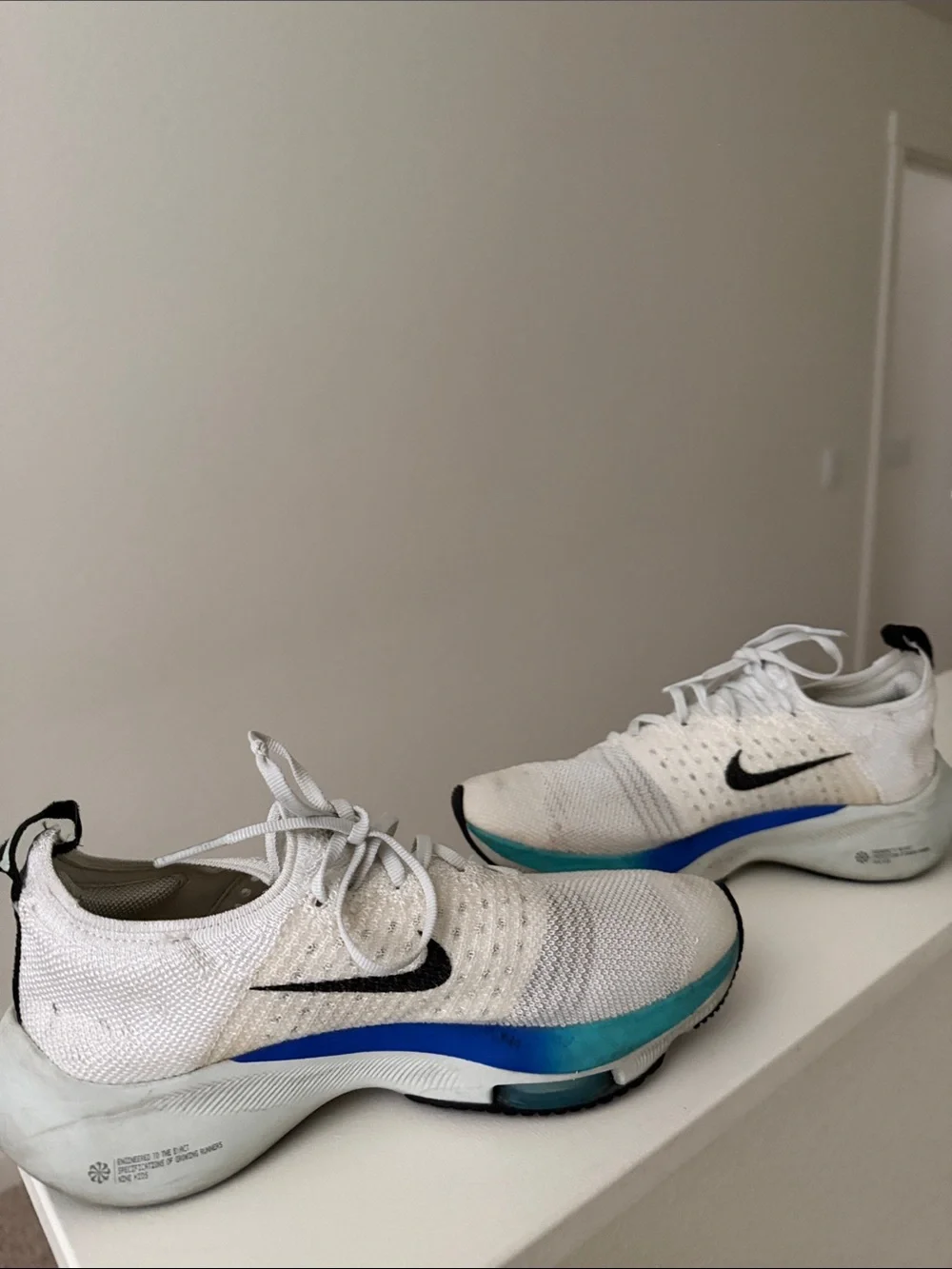 Nike White Running Shoes with Pink Accent and Black Swoosh